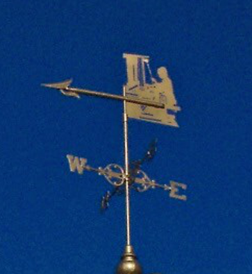Weathervane
Original weather vane on the cupola of Goodall Library, depicting a mill worker at a loom. Since the picture was taken (circa 2010) the metal has deteriorated so that the top of the loom has fallen off.
